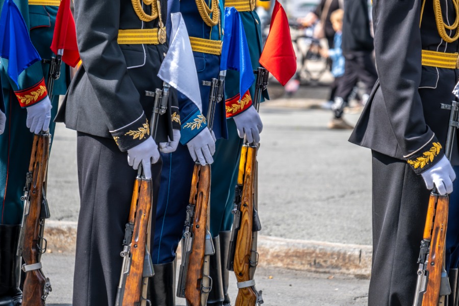 Military honor guard wearing white gloves during a formal ceremony