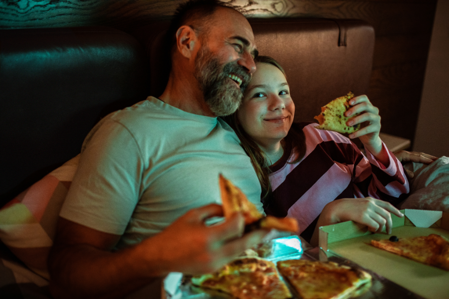 A family enjoying a shared takeout meal around the table