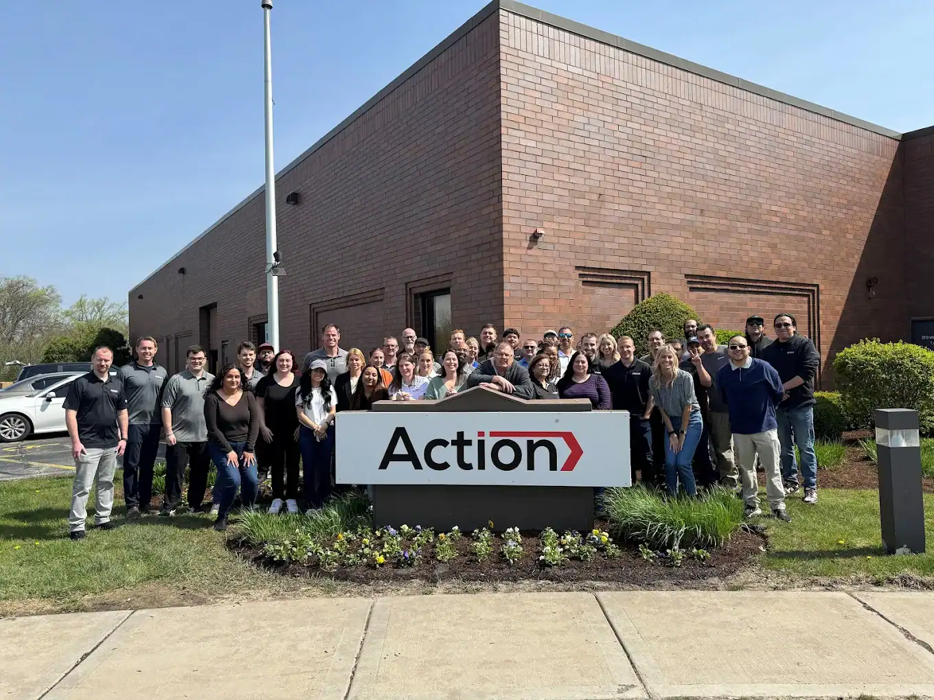 Action Packaging employees outside the company warehouse