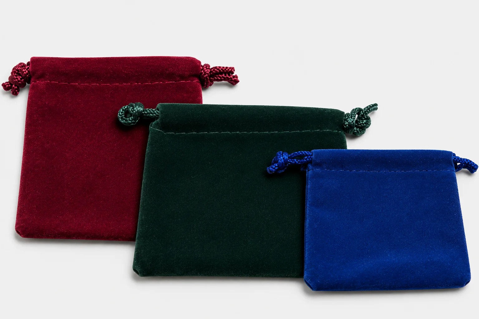 Red, green, and blue velveteen drawstring jewelry pouches